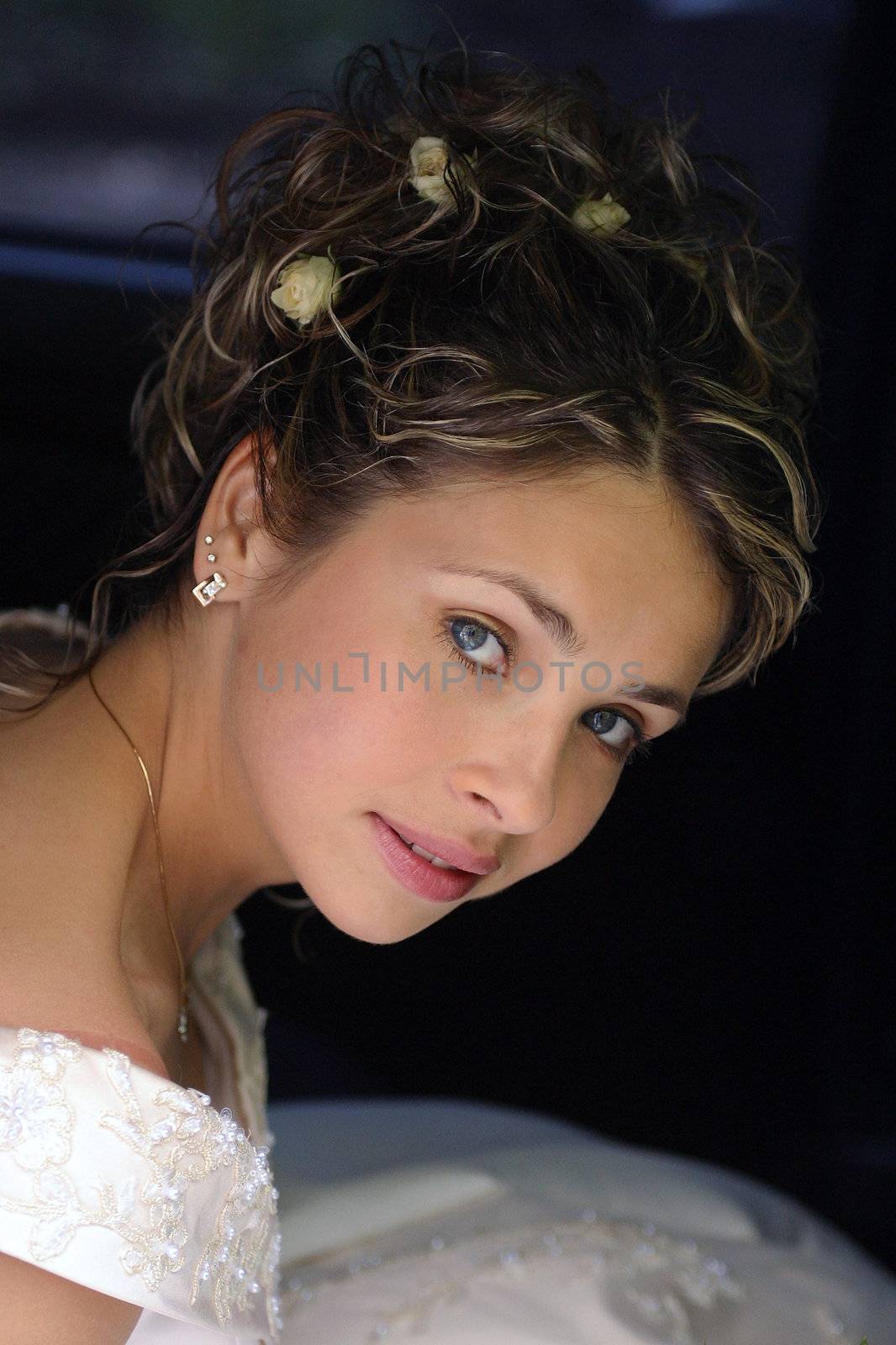 Beautiful bride traveling in wedding car limousine.