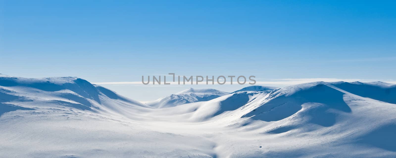 A snowy mountain landscape on a beautiful winter day. Picture taken in Oppdal, Norway.