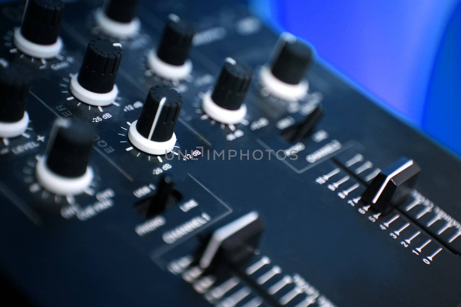 Close up of a panel control of a blue mixer table  in a studio