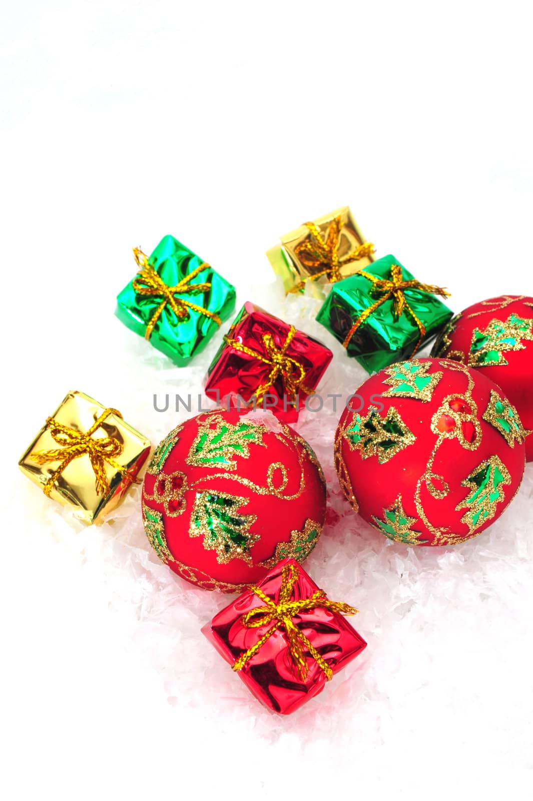 Red christmas tree ornaments and small colorful gifts