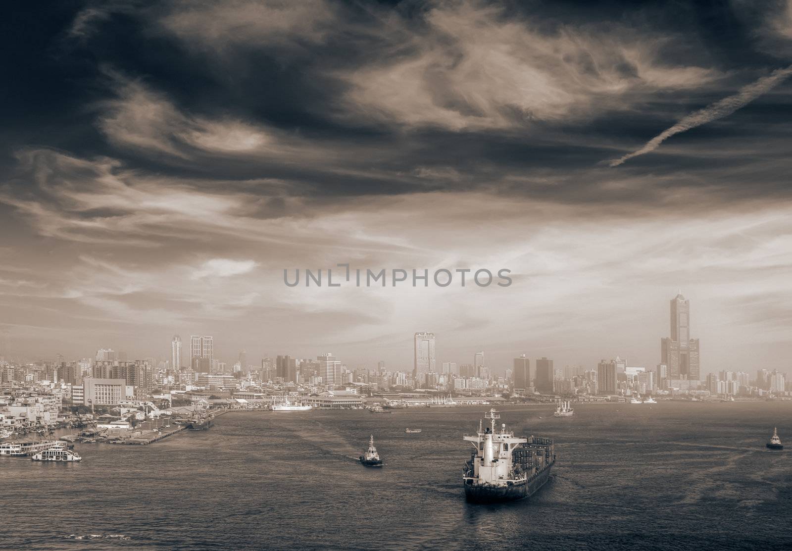 Cityscape of boats in port and city skyline in Kaohsiung, Taiwan.