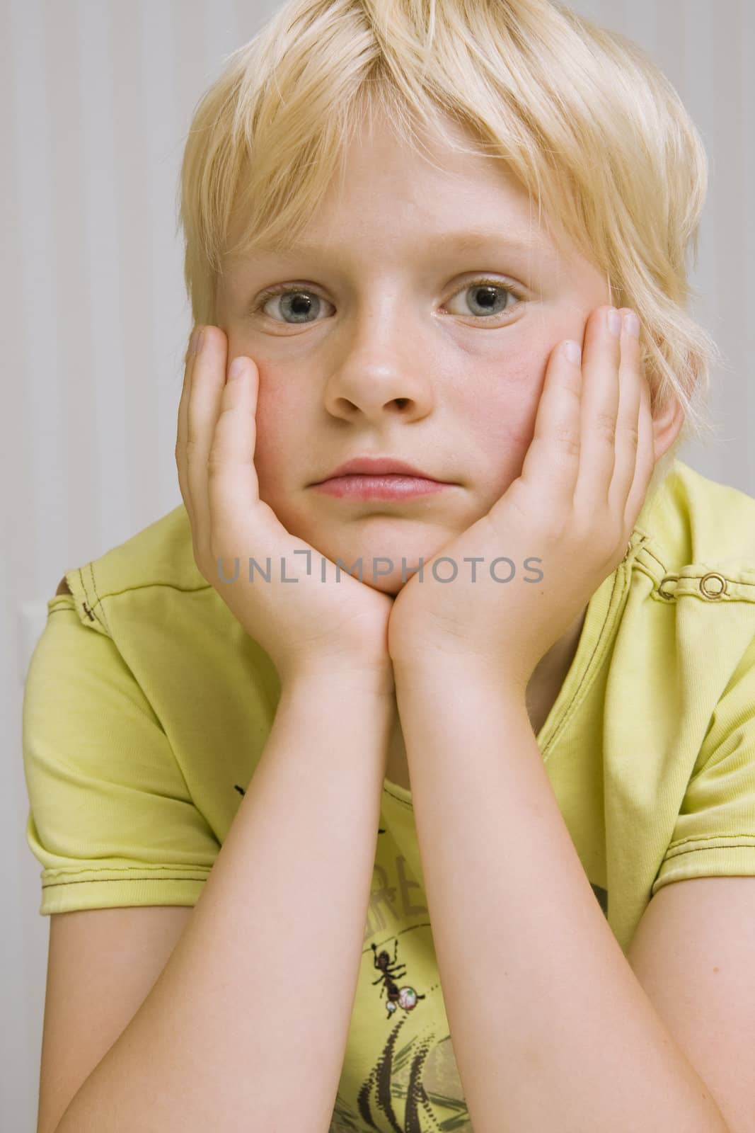 young cute blond boy thinking