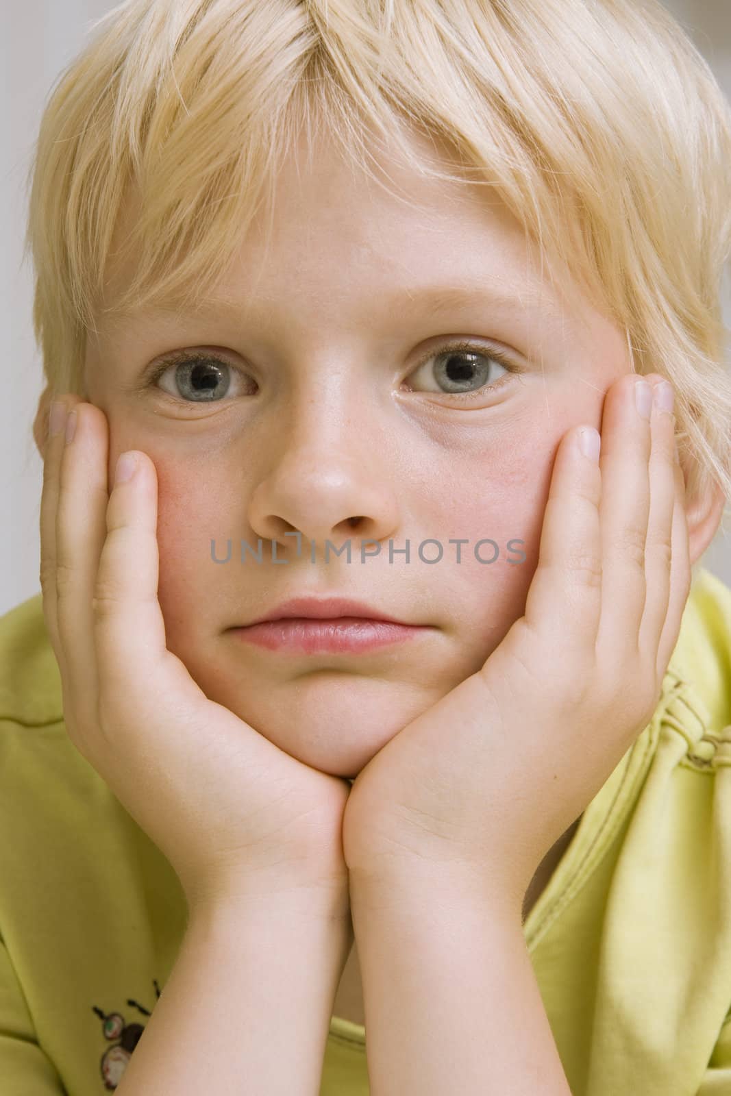 young cute blond boy thinking