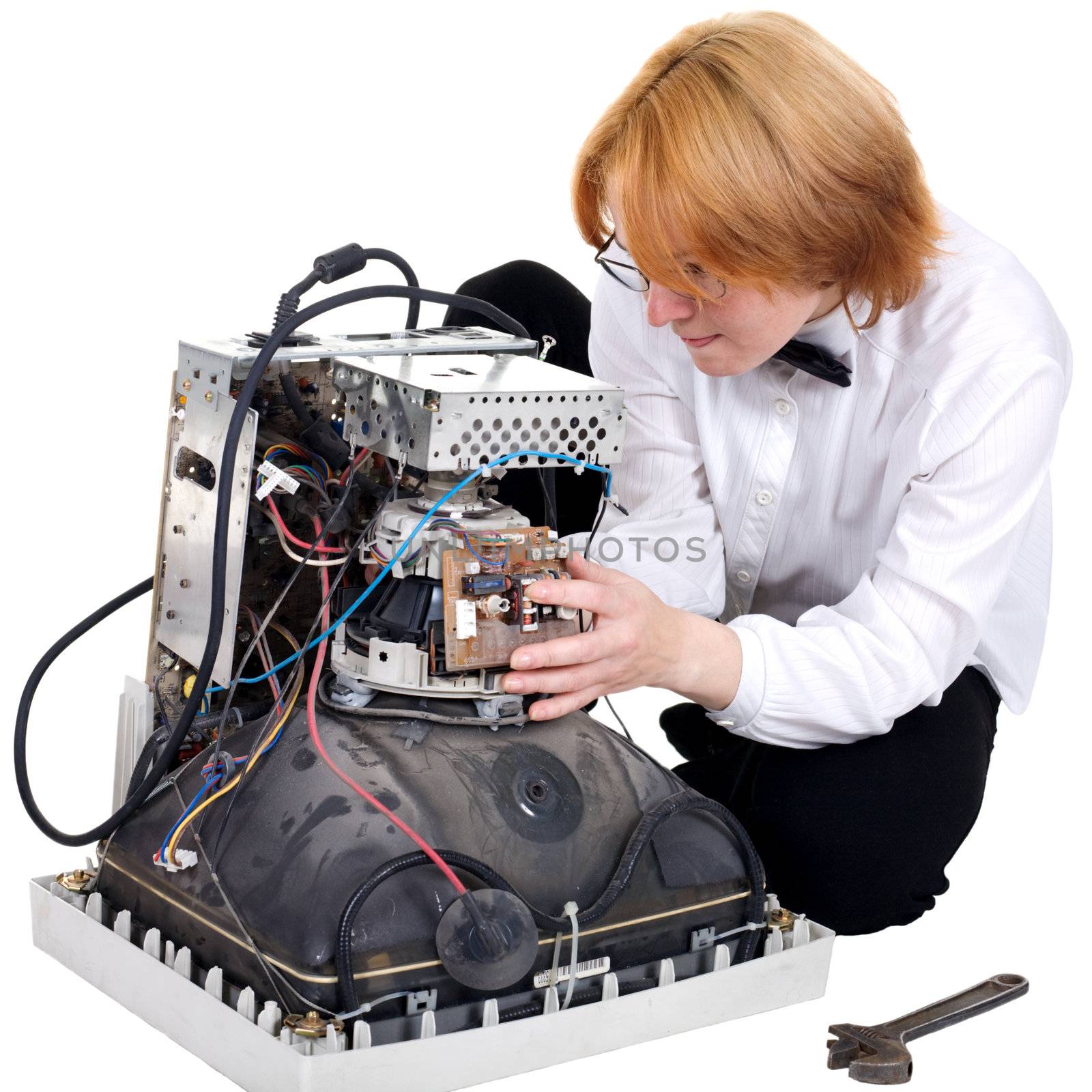 The girl repairing the old electronic equipment