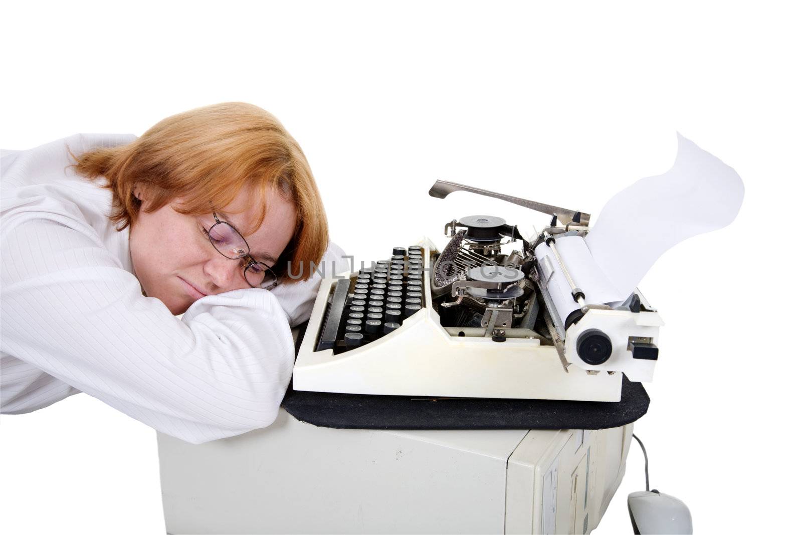 The woman sleeping on a workplace with a typewriter