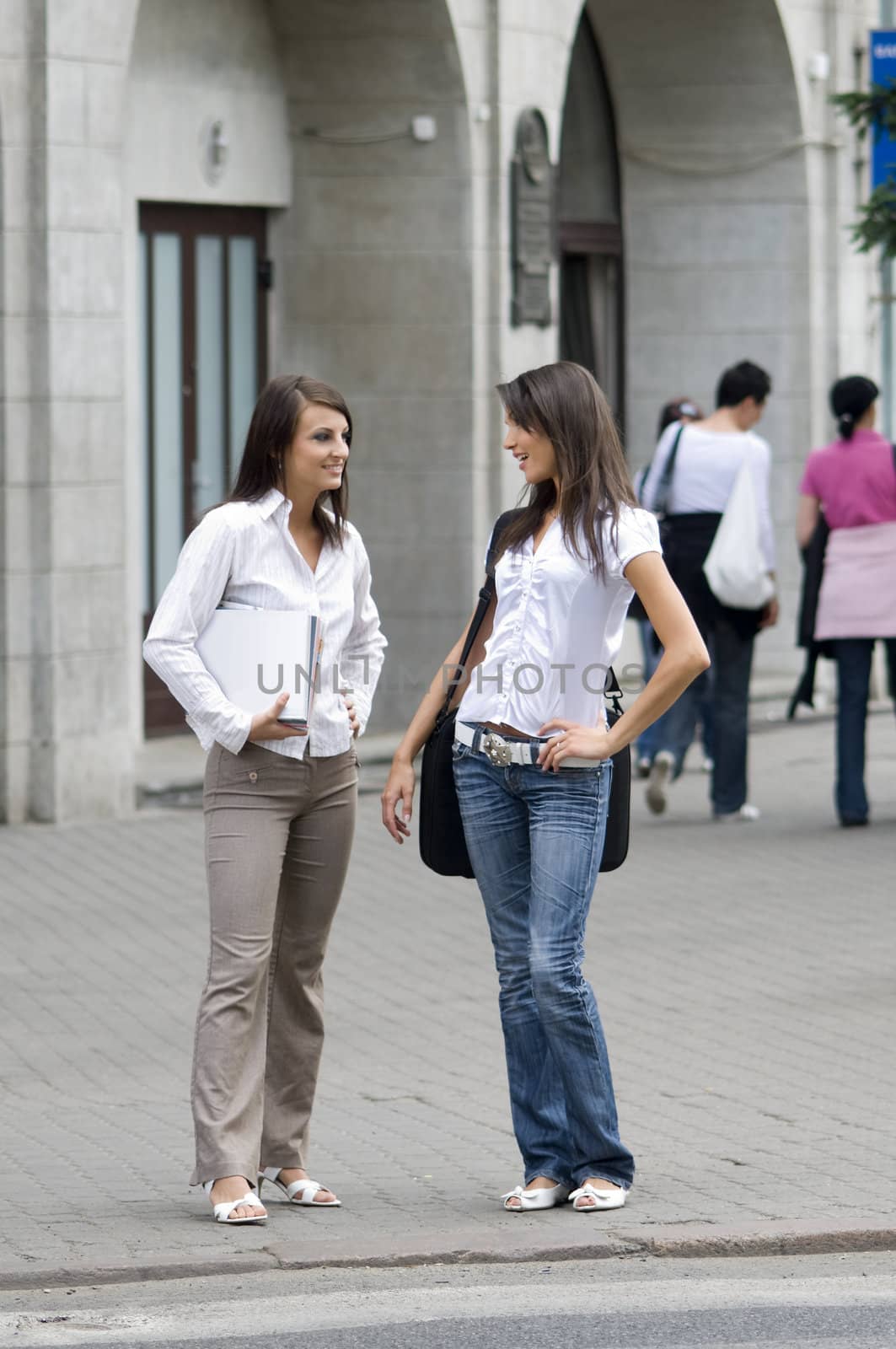 women chatting on the cross road in city center while they going to work