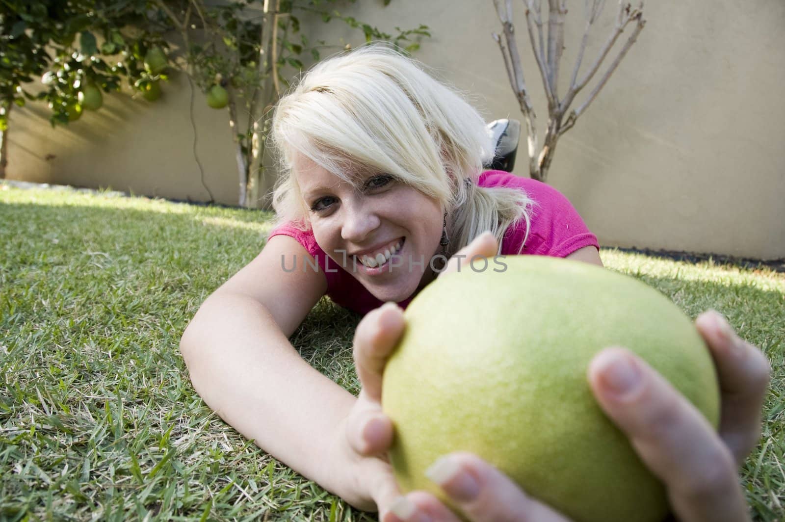 caucasian woman posing with sweet lime by imagerymajestic