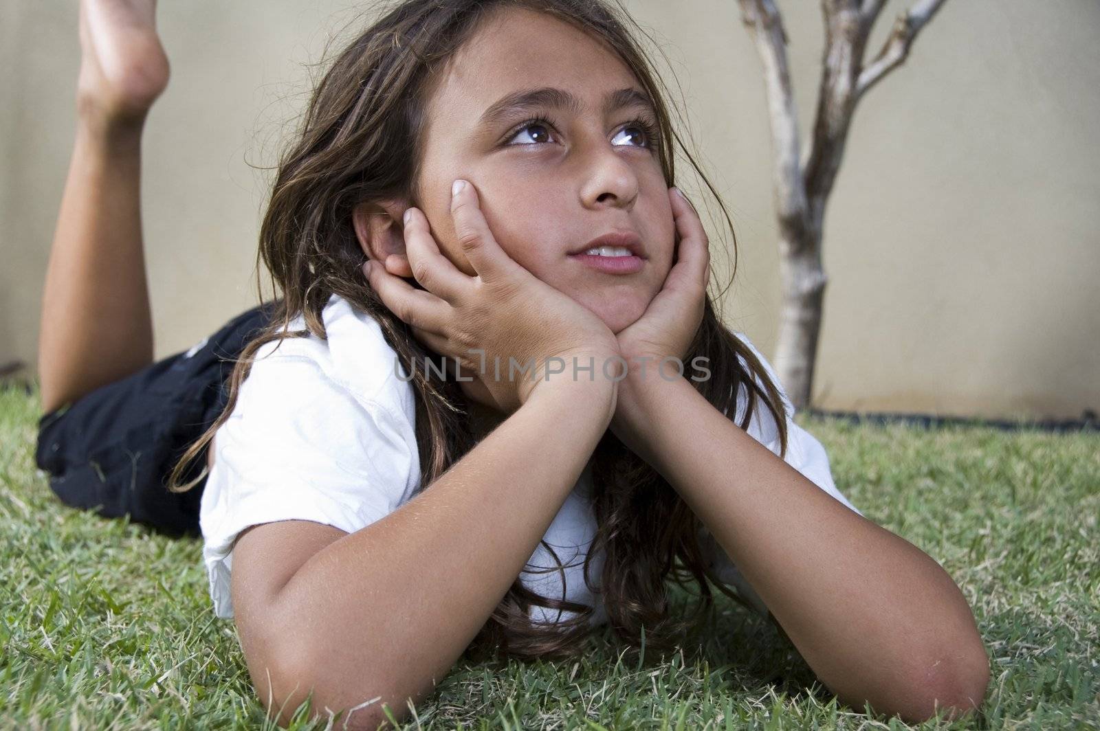 little boy lying on grass and looking aside by imagerymajestic