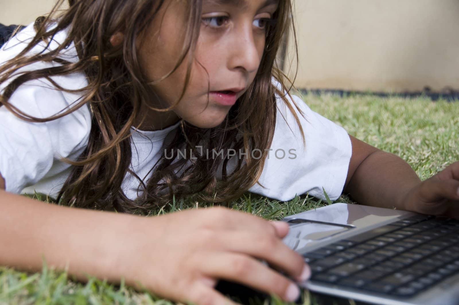 lying little american boy playing with laptop