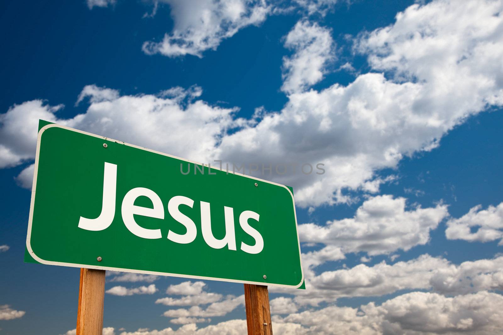 Jesus Green Road Sign with Copy Room Over The Dramatic Clouds and Sky.