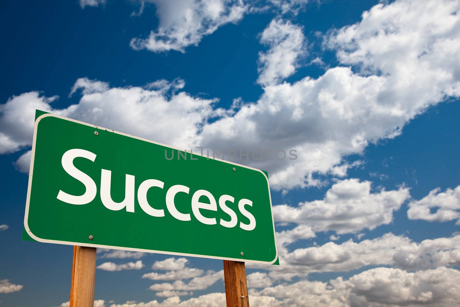Success Green Road Sign with Copy Room Over The Dramatic Clouds and Sky.