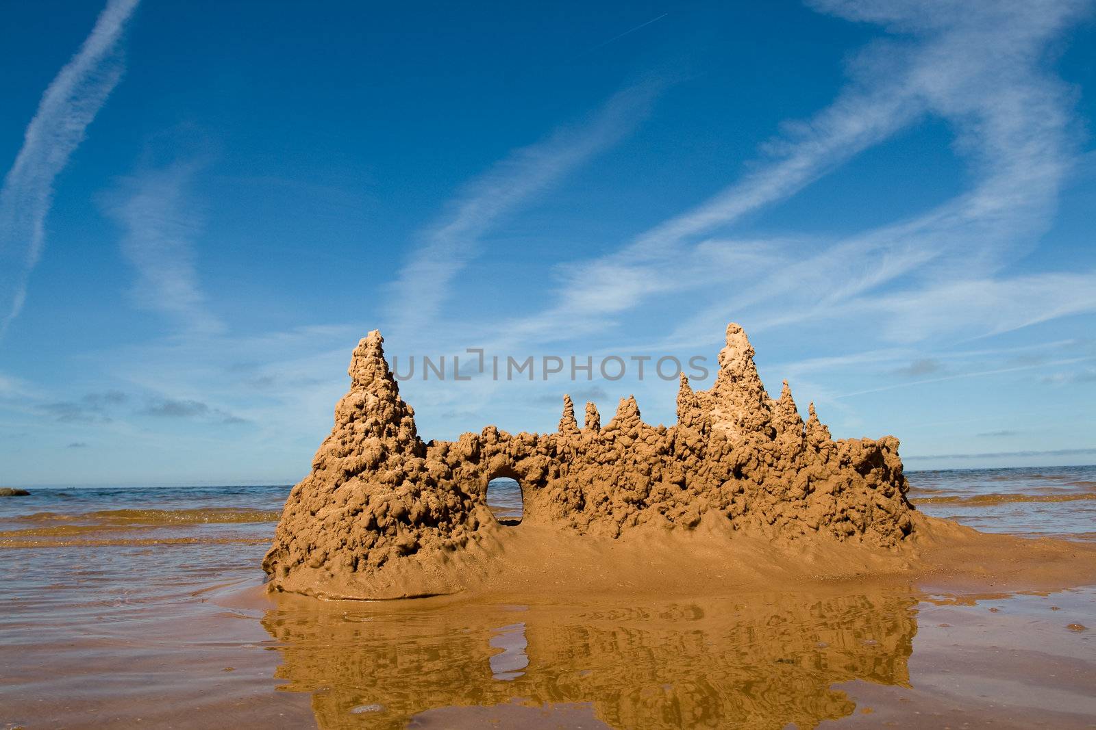 Sand castle at the beach by ints