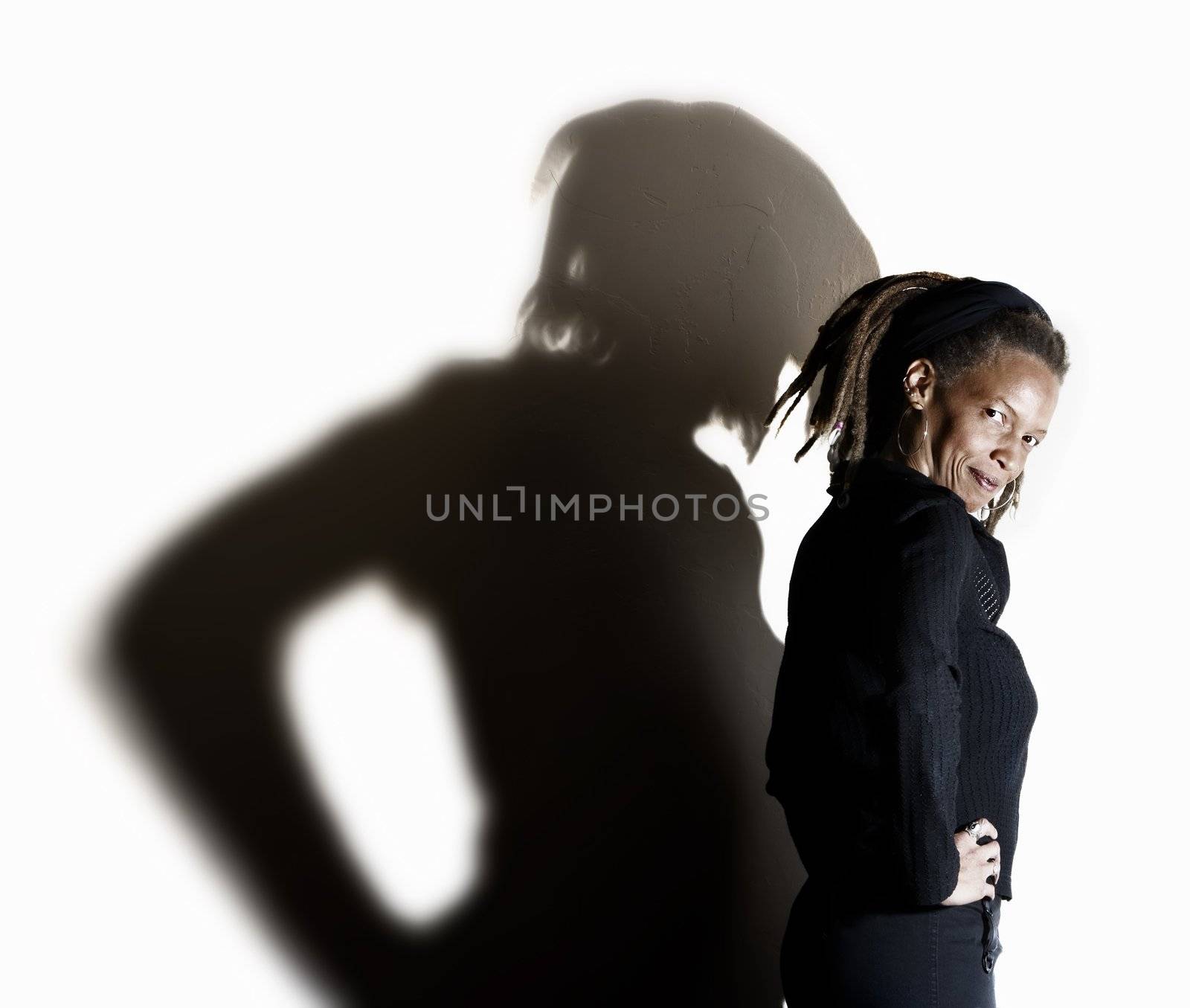 African American woman with dreadlocks against a white wall