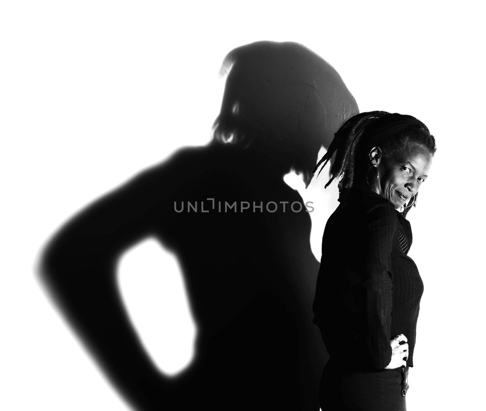 African American woman with dreadlocks against a white wall