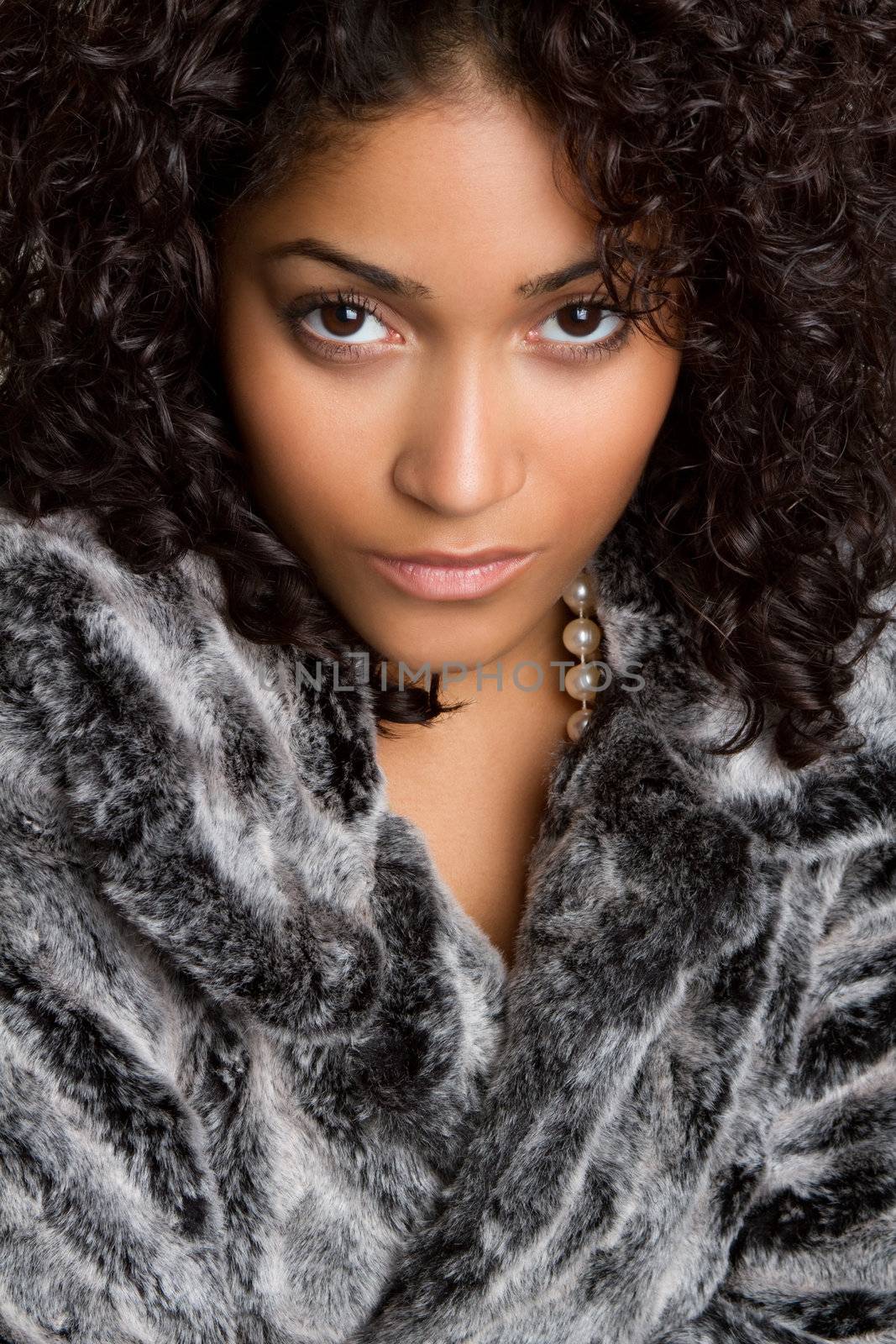 Beautiful black woman wearing fur coat