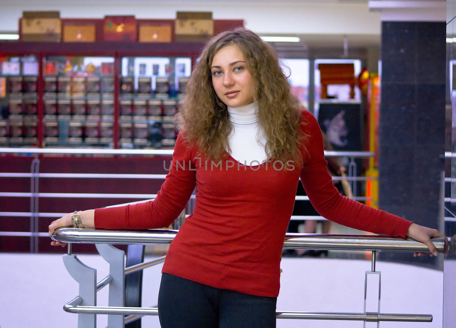 Portrait of the happy young girl in shop