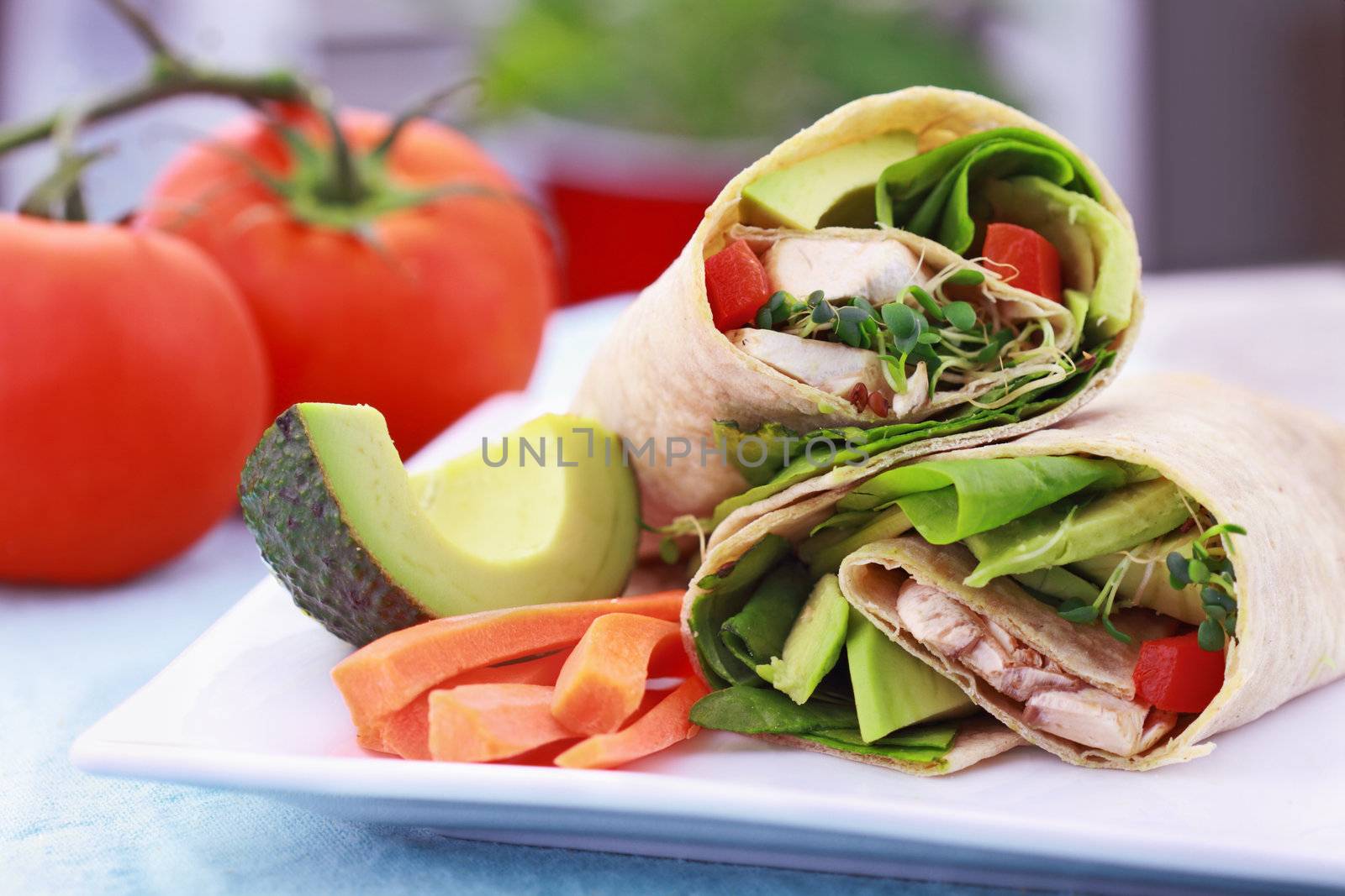 Vegan sandwich wrap with Lavish bread made from flax, oats and whole wheat. Stuffed with fresh spinach, sprouts, mushrooms, red peppers and avocados for a healthy lunch.