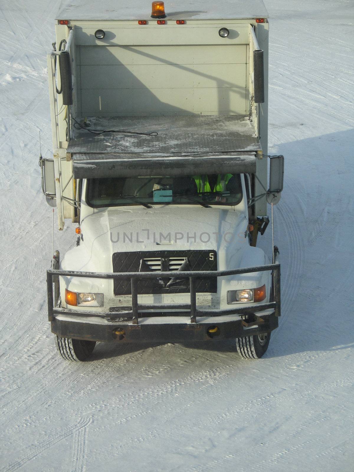 a truck on snow driving on white snow