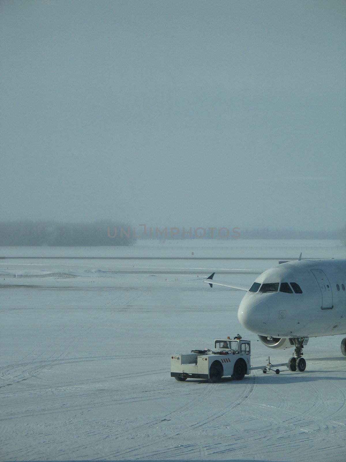towed airplane in the winter