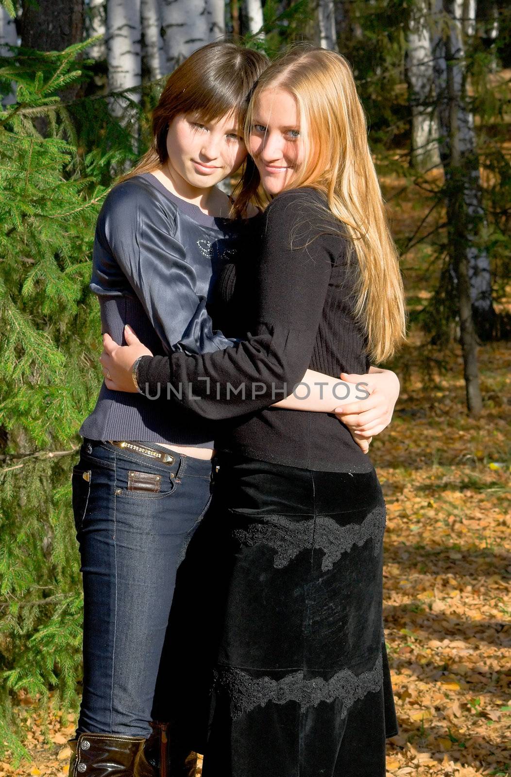 Two girlfriends in autumn park