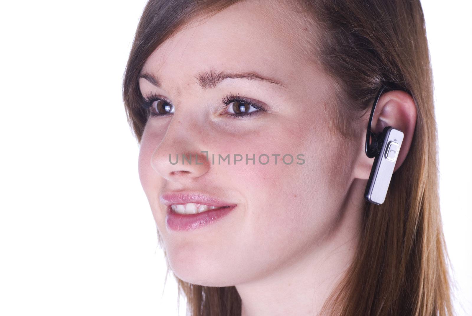 Teenage girl with headset isolated on a white background.