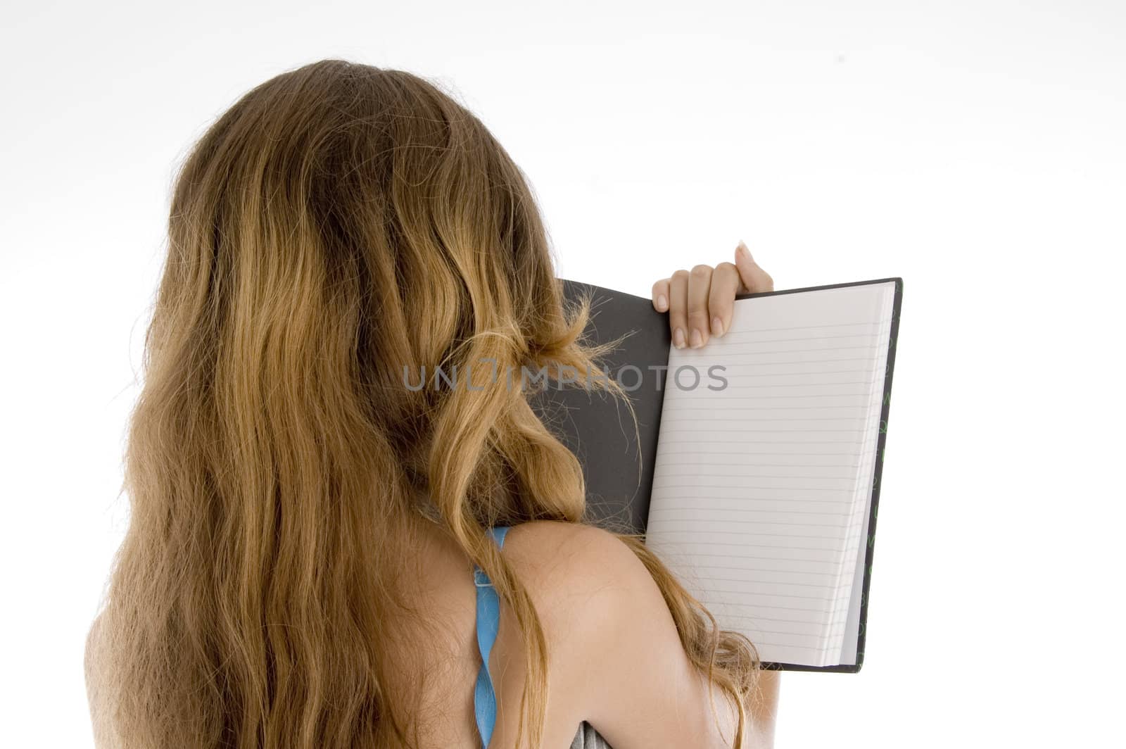 back pose of girl reading note book on  an isolated white background 