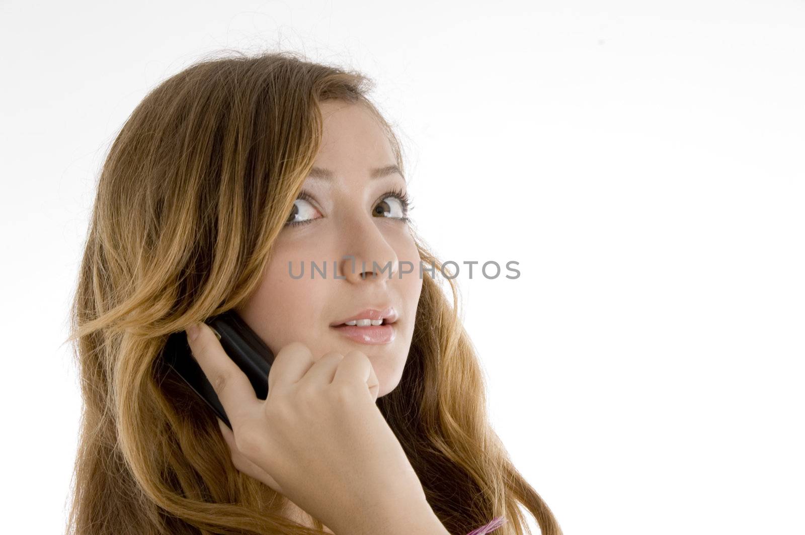 beautiful female talking on mobile lphne ooking upward on  an isolated white background 