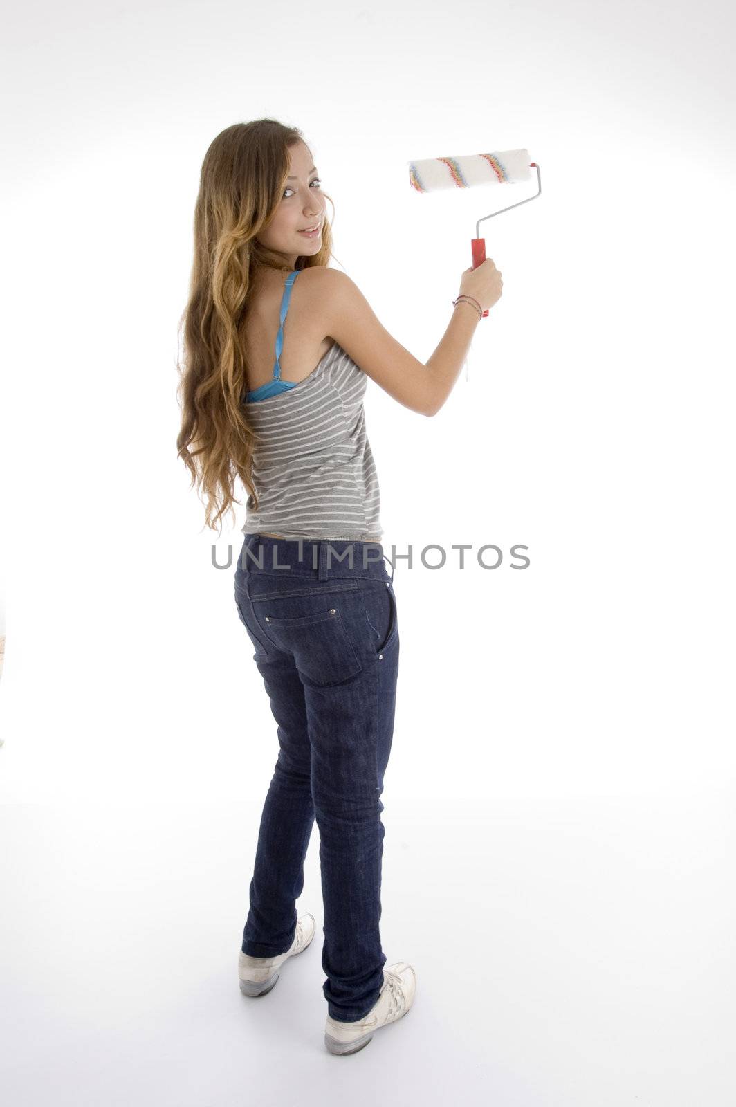 standing pose of young female painter with roller brush on  an isolated white background 