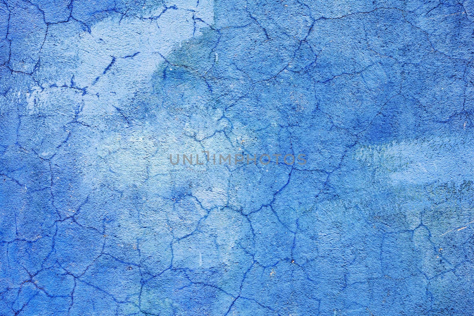 The blue wall are covered with cracked plaster