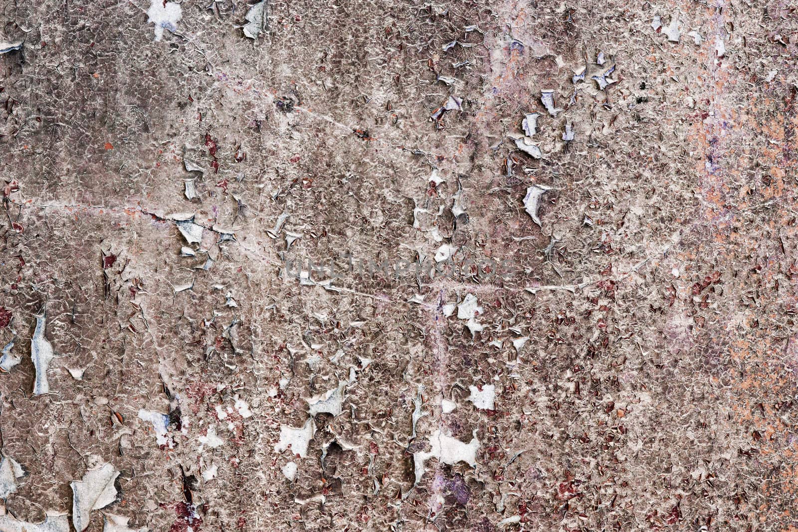 Dirty old stone wall with peeling paint rags
