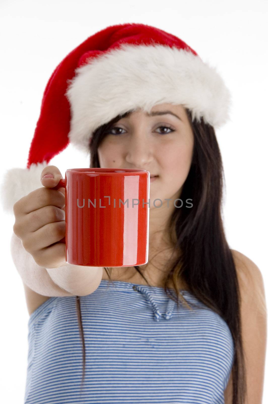 girl with mug and christmas hat on  an isolated white background 