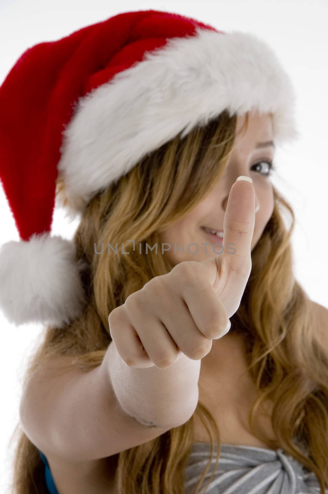 girl with christmas hat showing her thumb on  an isolated white background 