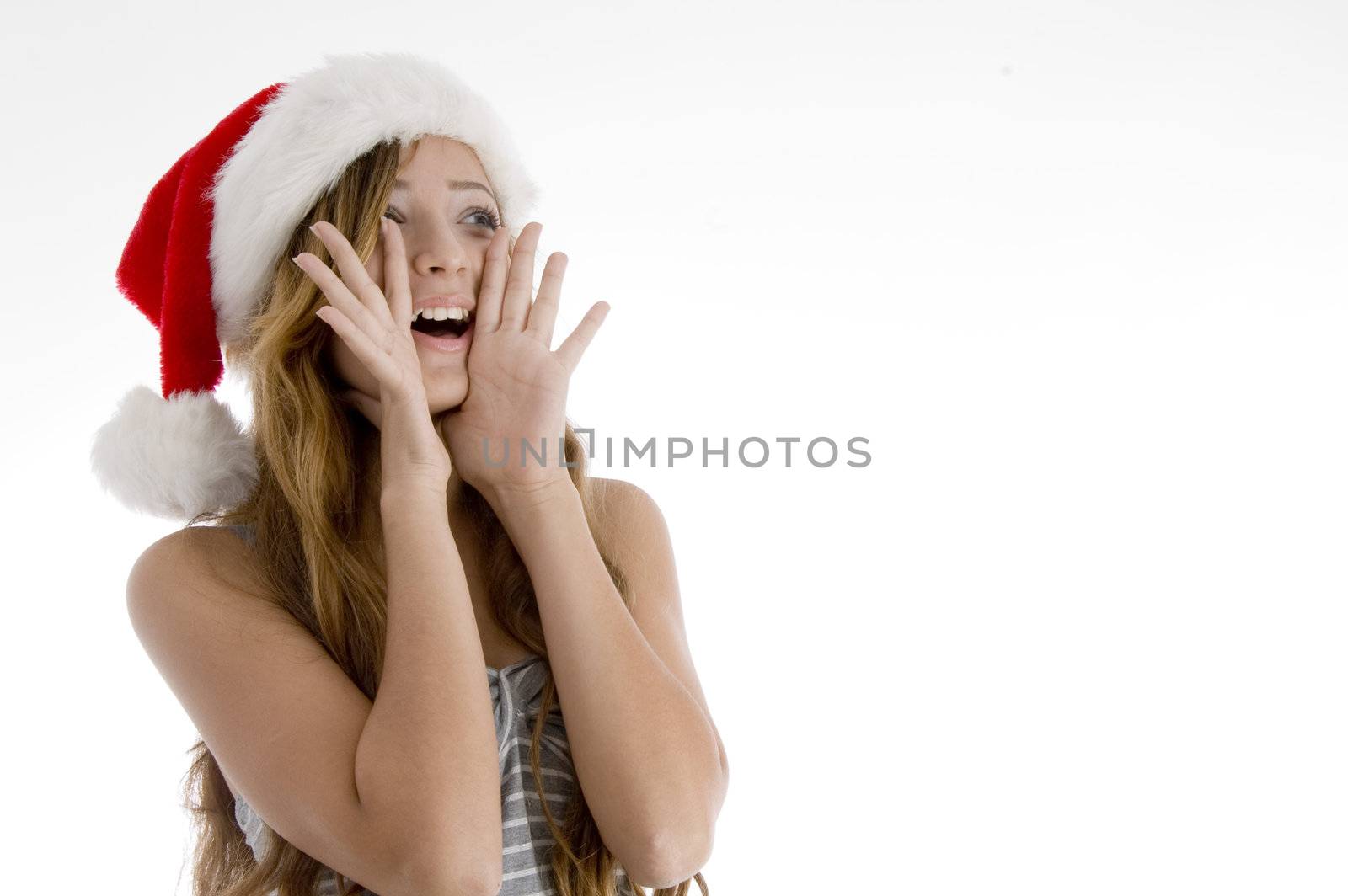 shouting young girl with christmas hat on  an isolated white background 