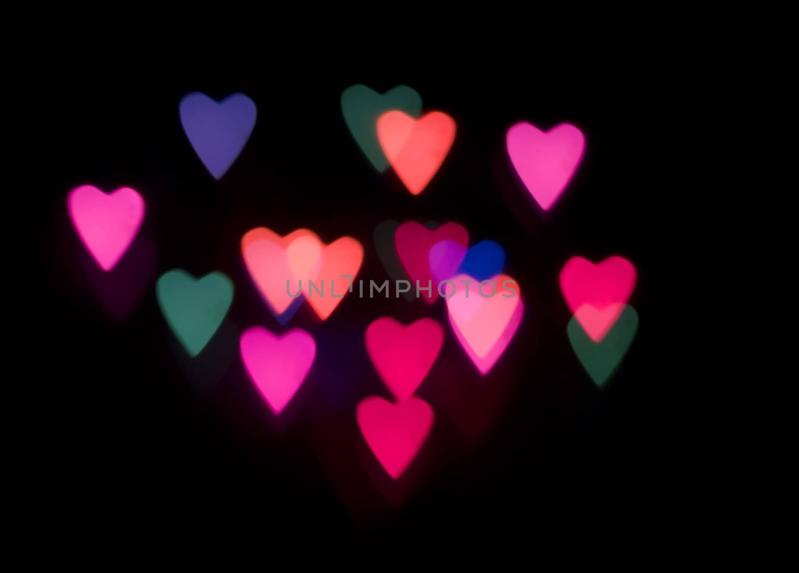 multi coloured heart shaped glowing lights on a black backdrop