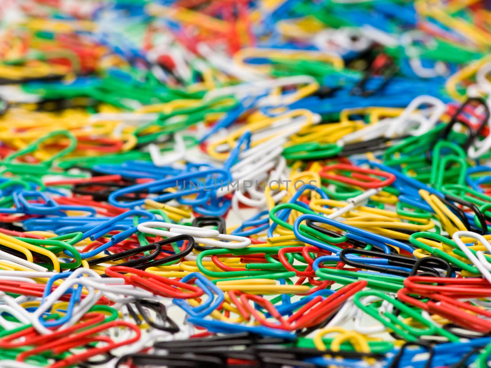 Paper clips of different colors background