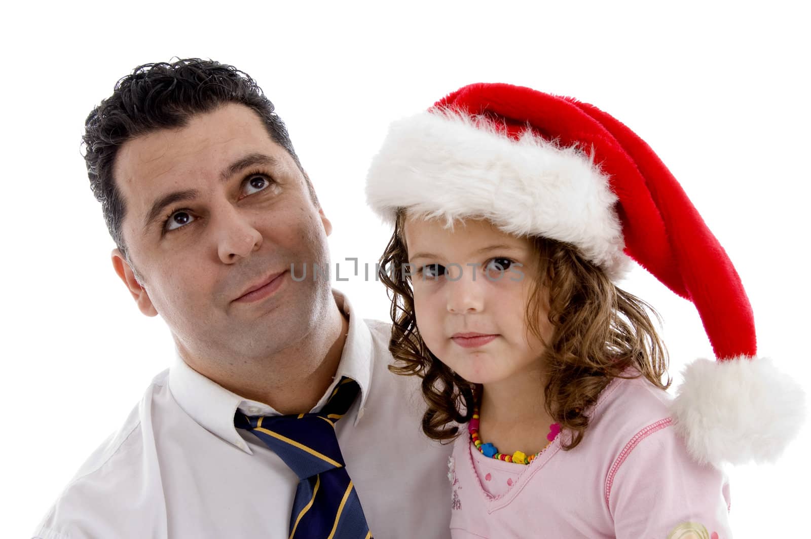 girl wearing christmas hat posing with her father by imagerymajestic