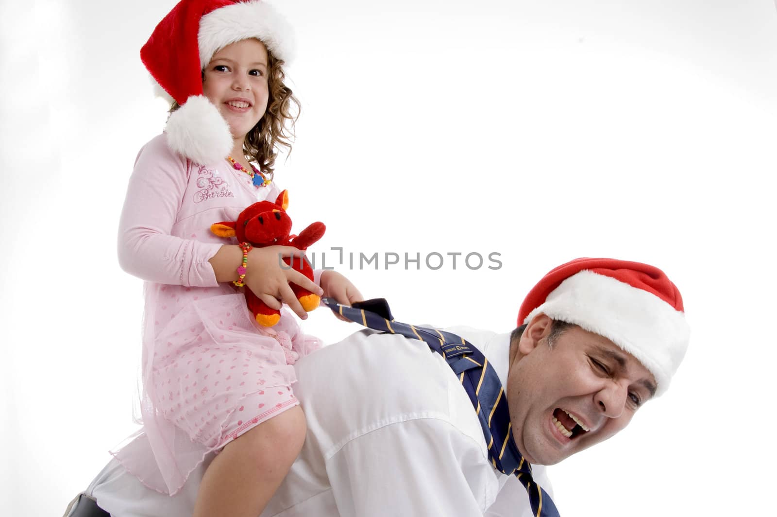 smiling little girl sitting on her father's back