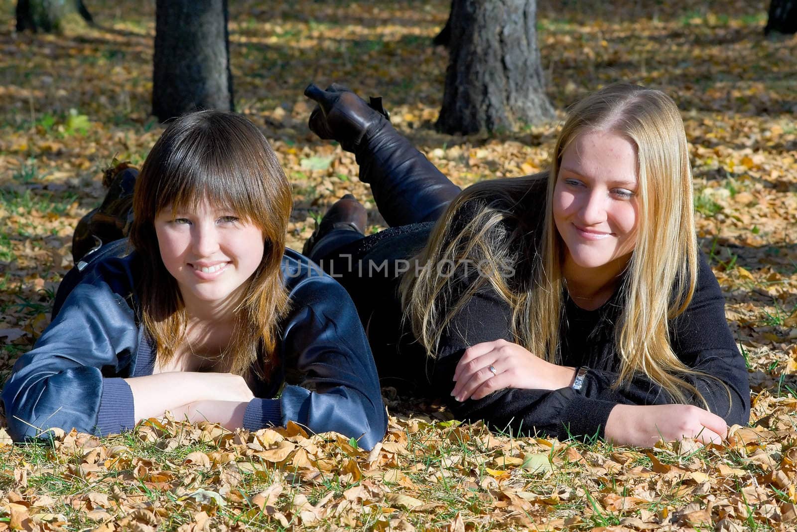 Two girlfriends against the autumn nature