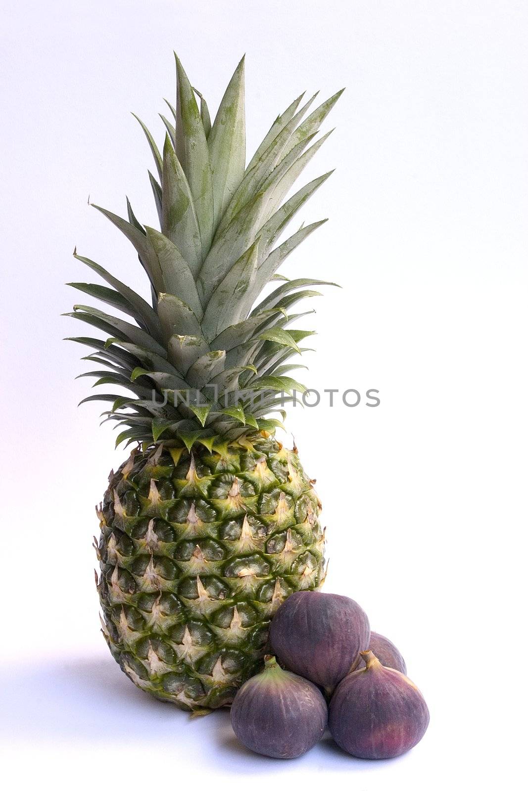 Fresh ananas and figs isolated on white background.