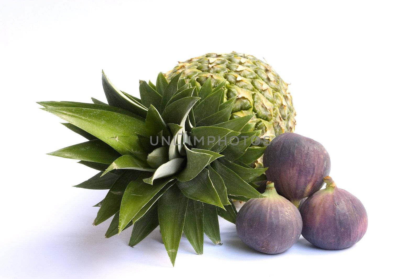 Fresh ananas and figs isolated on white background.