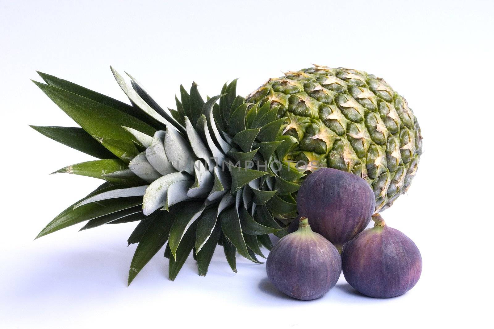 Fresh ananas and figs isolated on white background.
