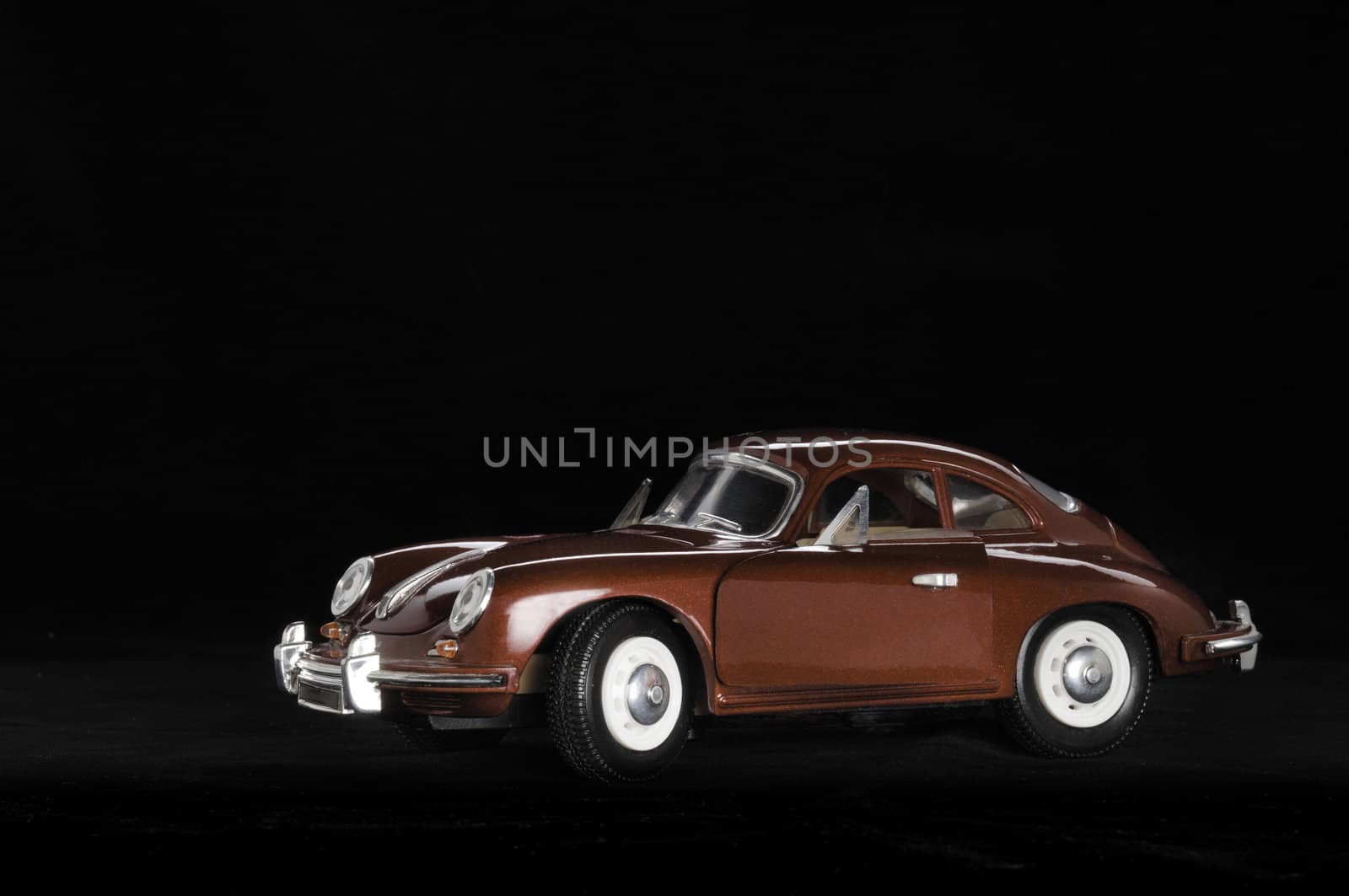 Toy car. Black background.