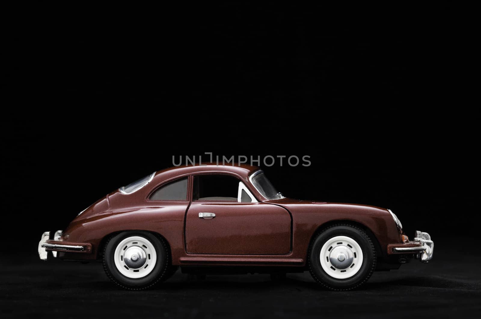Toy car. Black background.