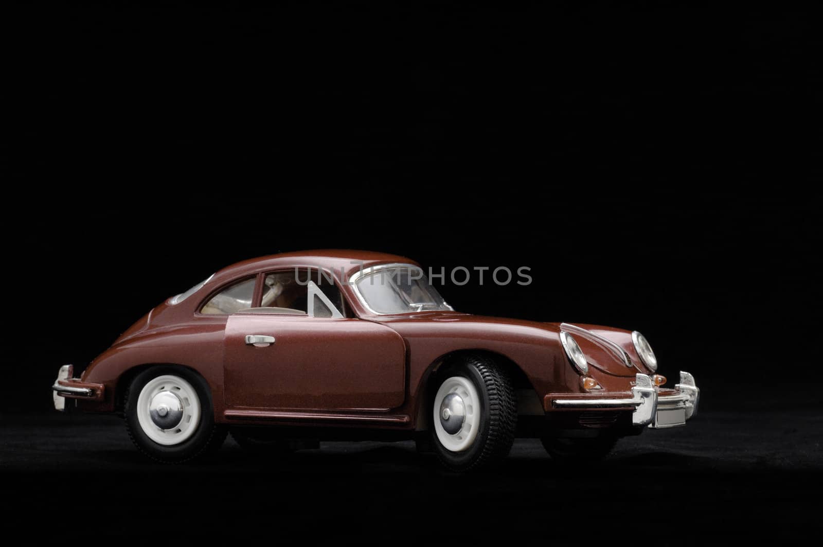 Toy car. Black background.