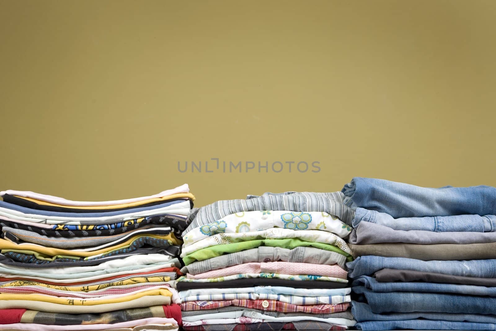 front view of color stacked clothes: shirt, denim, t-shirt