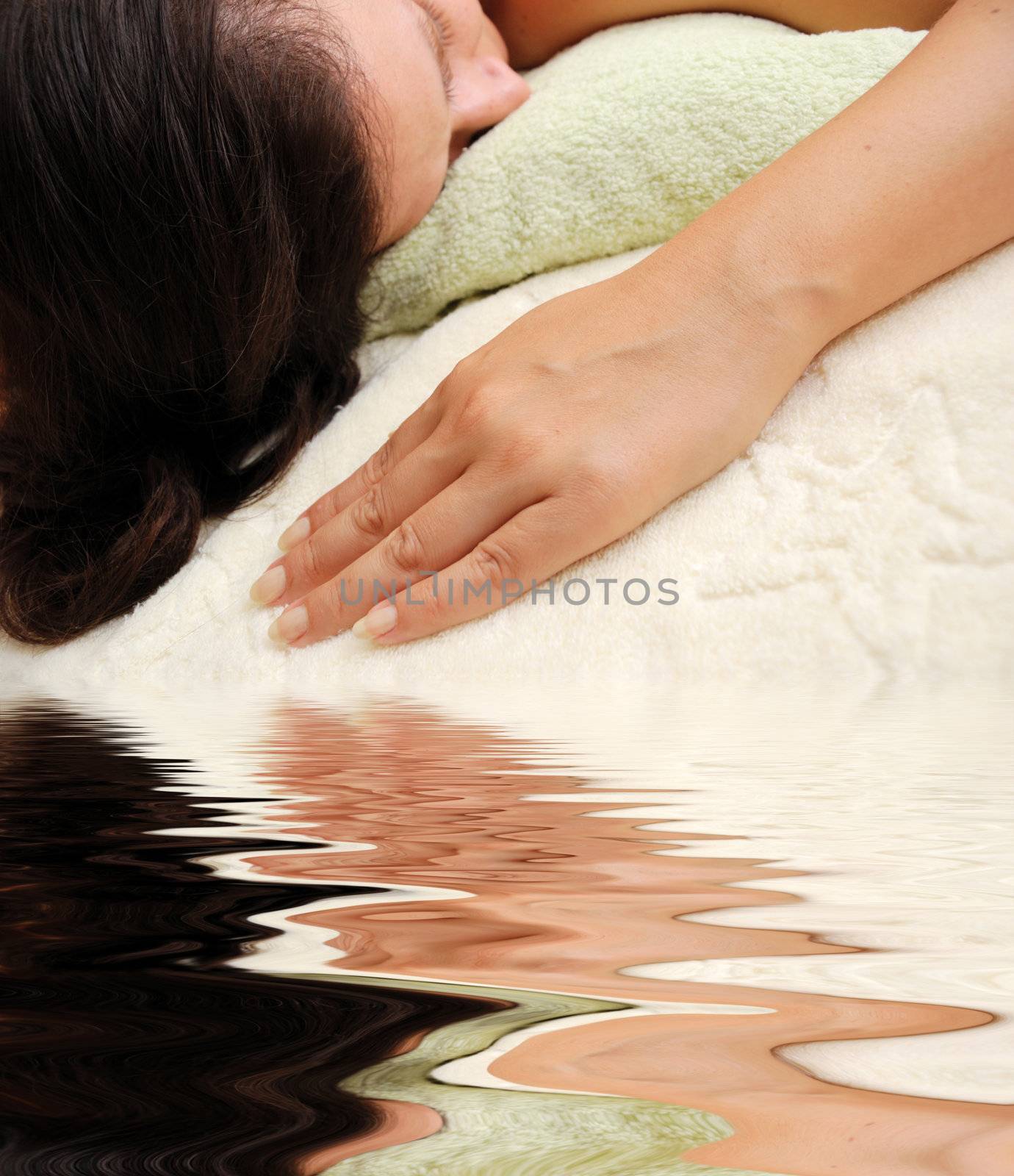 concept of spa - female laying over towels