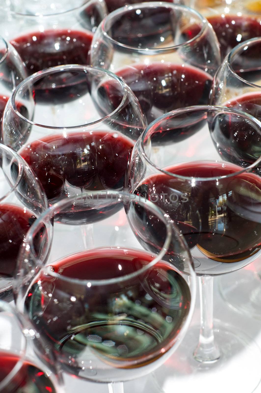 group arrangement of glasses with red wine, selective focus
