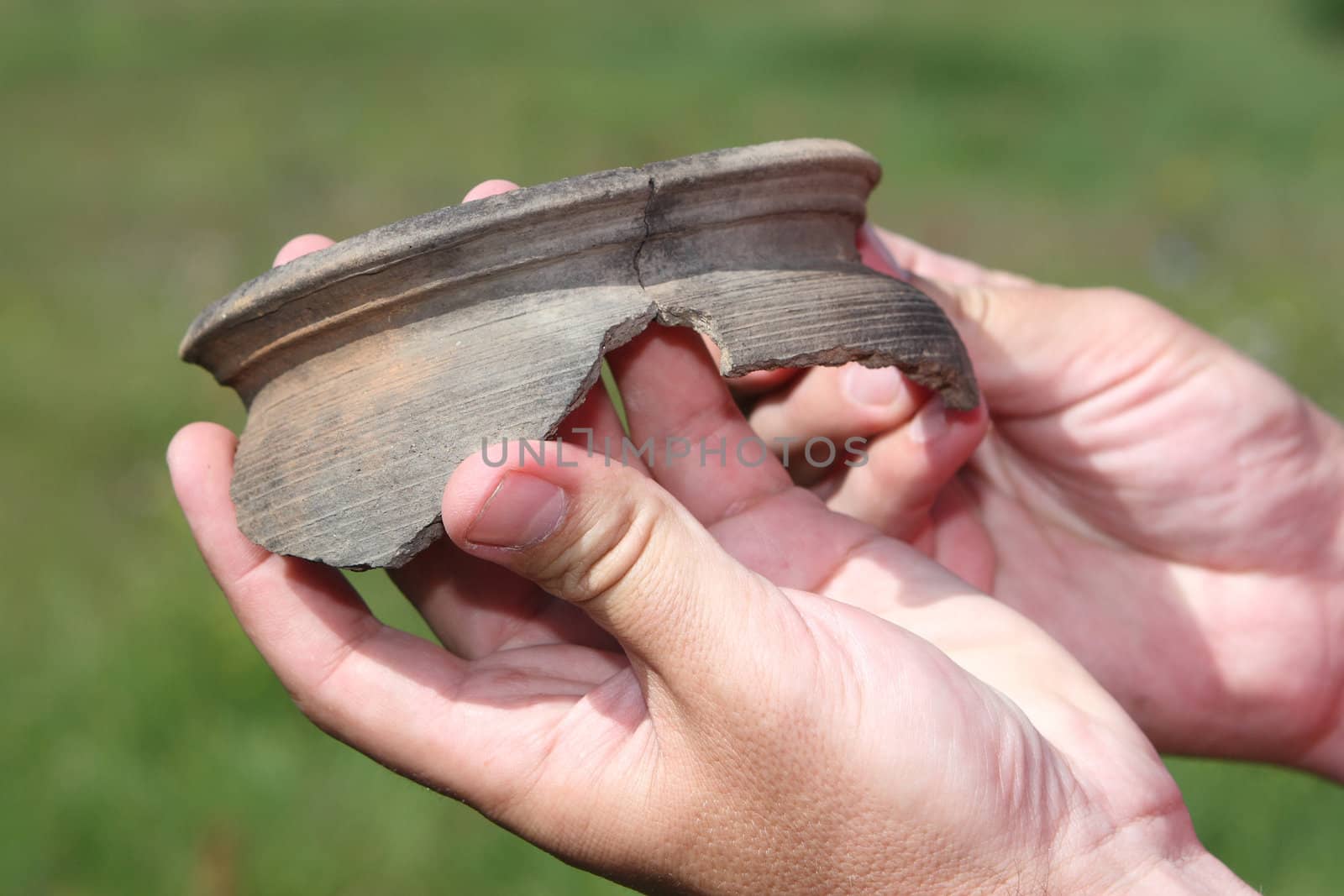Clay crocks in man's hands