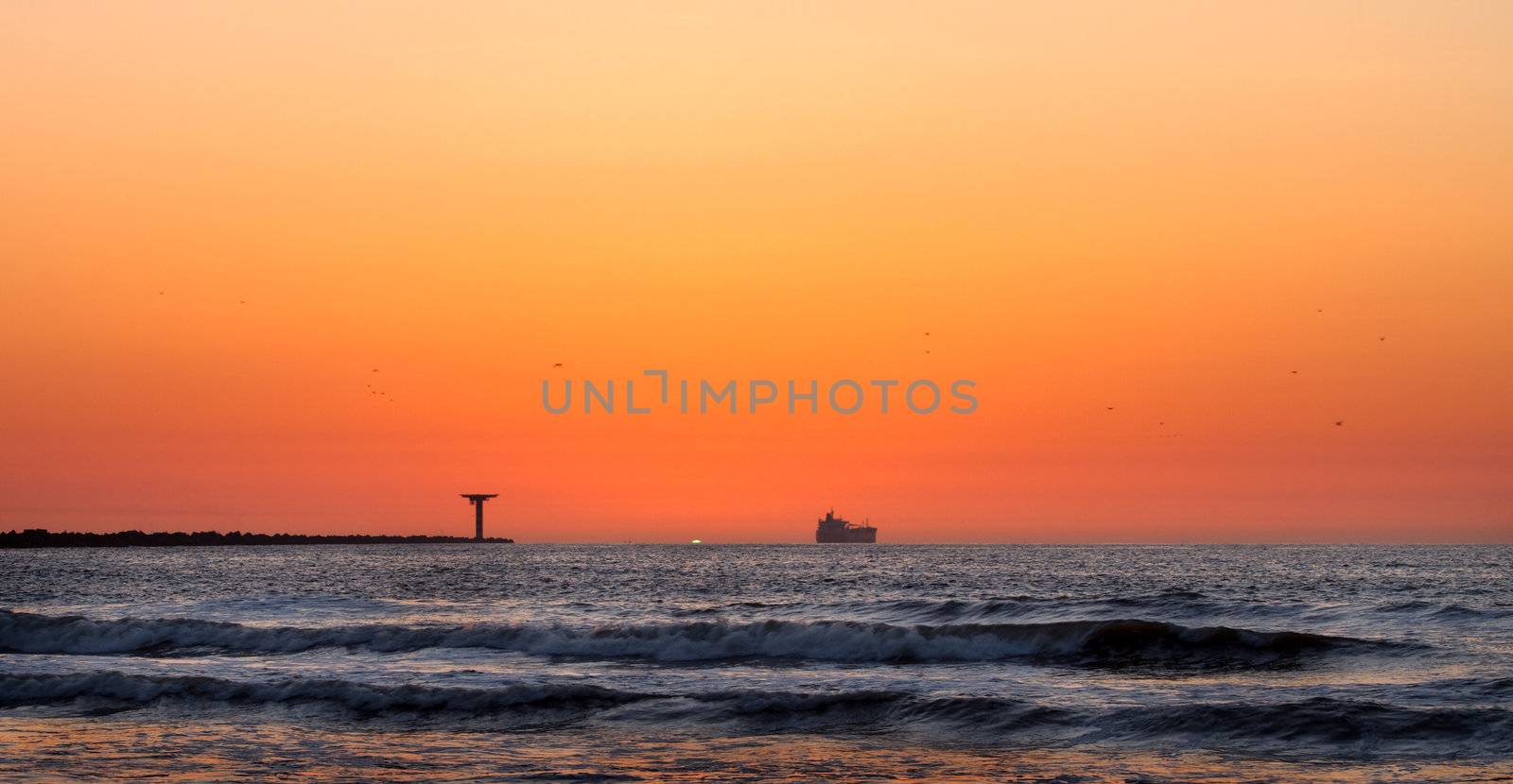 Colorful and hazy sunset at the coast with volcanodust in the air and Green Flash