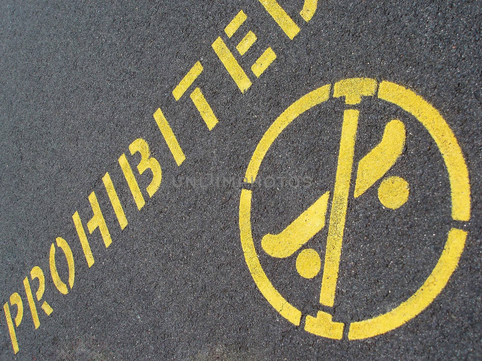 skateboarding prohibited sign on a tarmac pavement